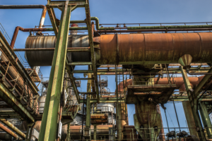 low-angle-shot-metal-structures-pipes-with-clear-sky